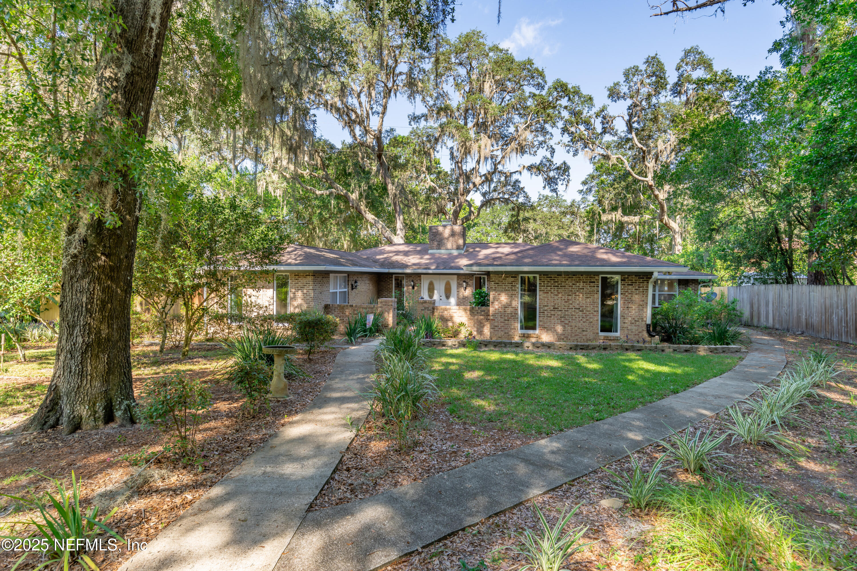 8048 County Line Road Melrose, FL 32666 - Photo 5 of 40 a front view of a house with garden
