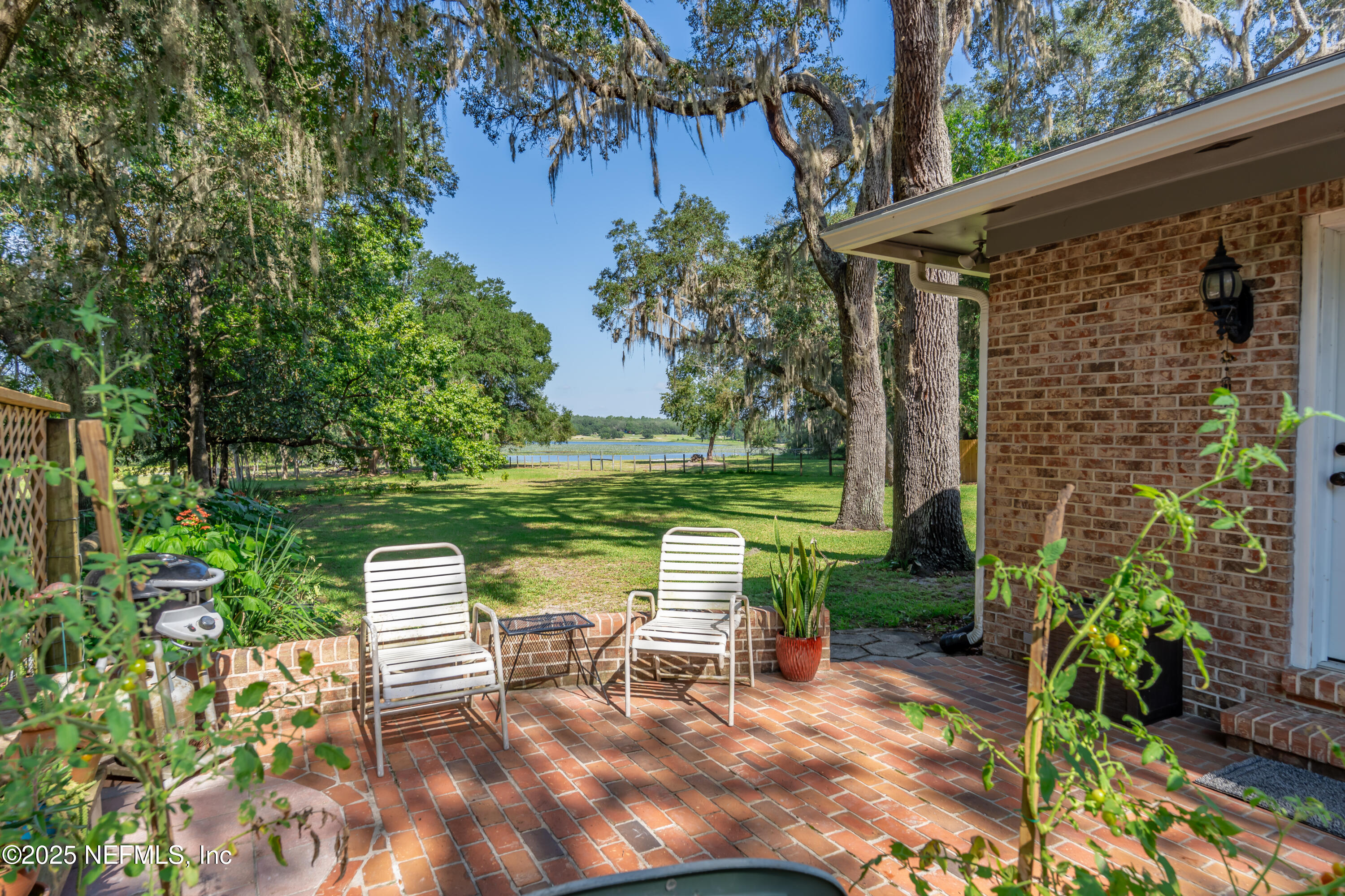 8048 County Line Road Melrose, FL 32666 - Photo 8 of 40 a view of a chair and table in backyard of the house