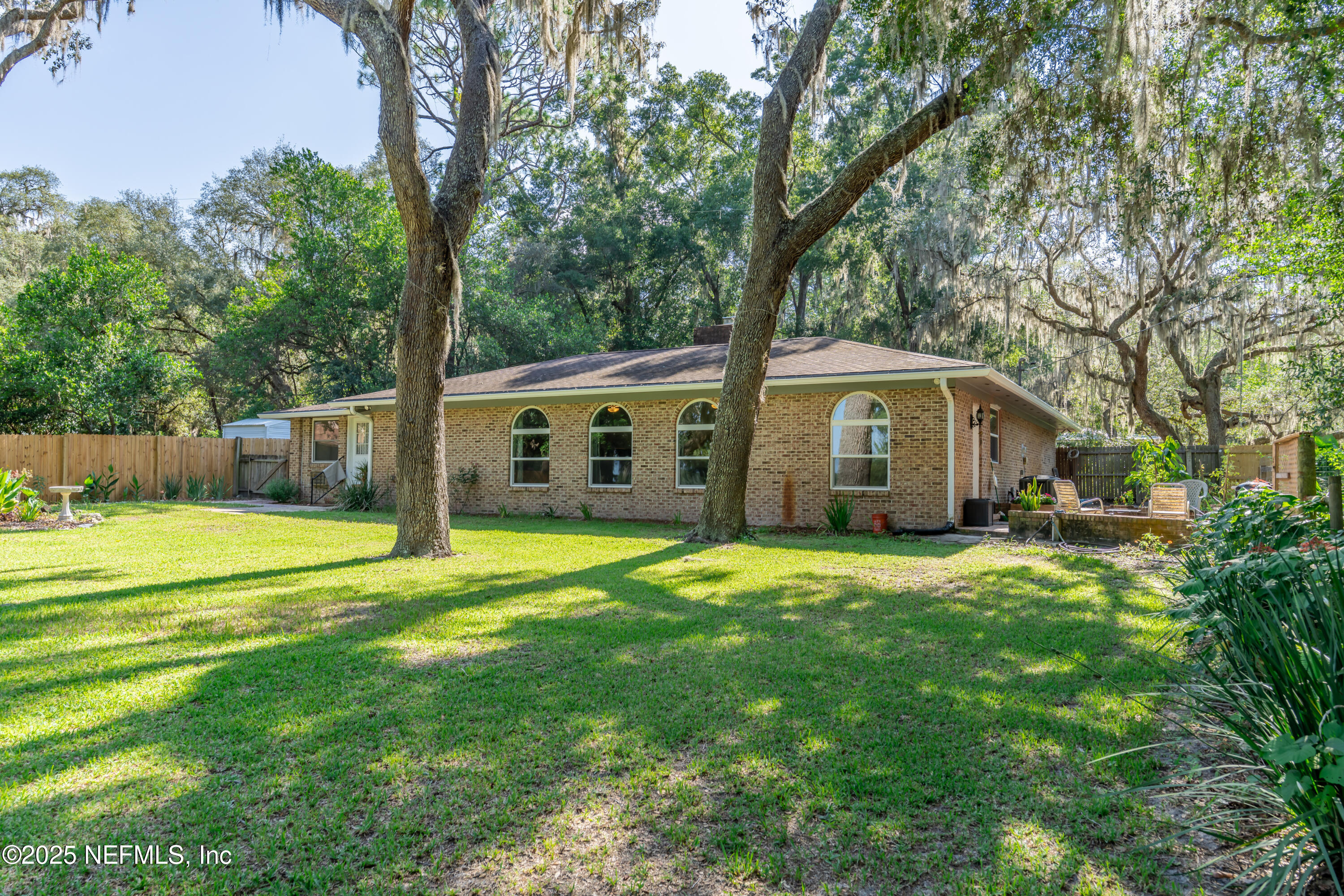 8048 County Line Road Melrose, FL 32666 - Photo 9 of 40 a front view of a house with a yard and trees