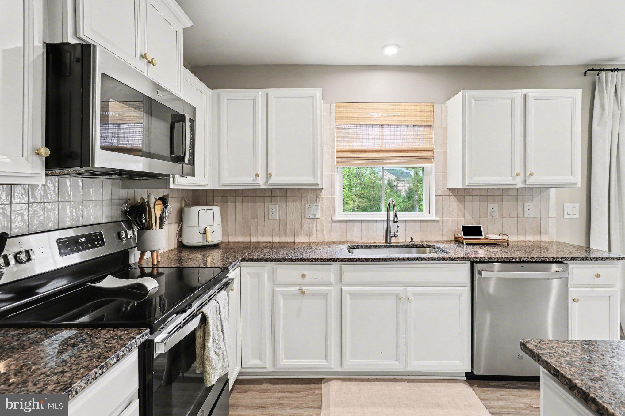 7202 Parchment Circle Ruther Glen, VA 22546 - Photo 9 of 30 a kitchen with granite countertop a stove sink and cabinets