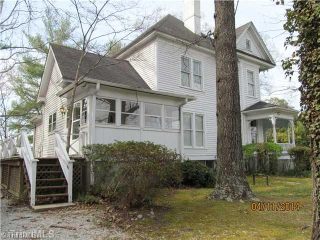 922 Spring Street Mount Airy, NC 27030 - Photo 14 of 15 Exterior Back. Left side of home and rear with sunroom and deck in rear