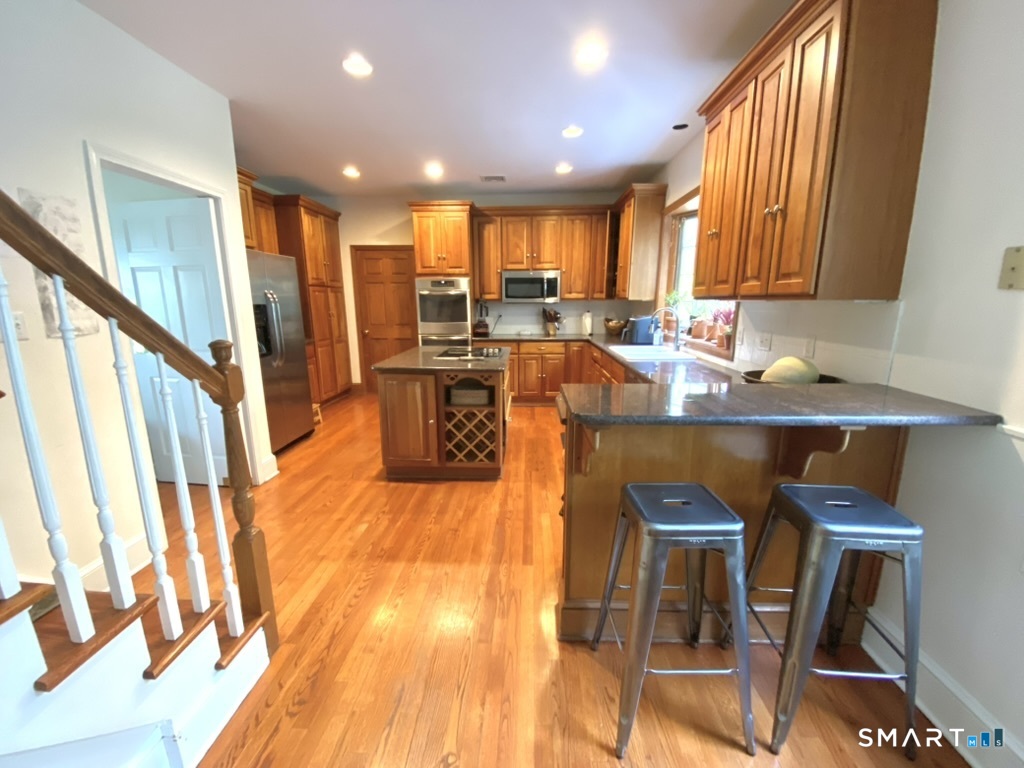 12 Carriage Hill Road Woodbridge, CT 06525 - Photo 9 of 24 a view of a dining room with furniture