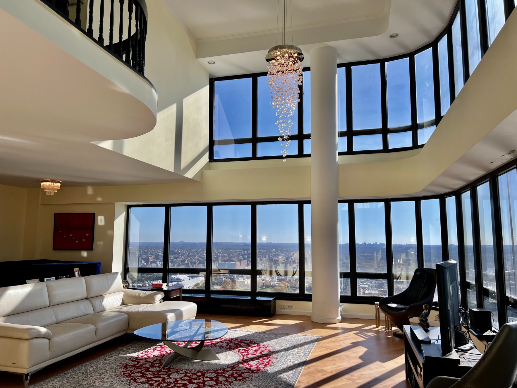 a living room with furniture and a floor to ceiling window