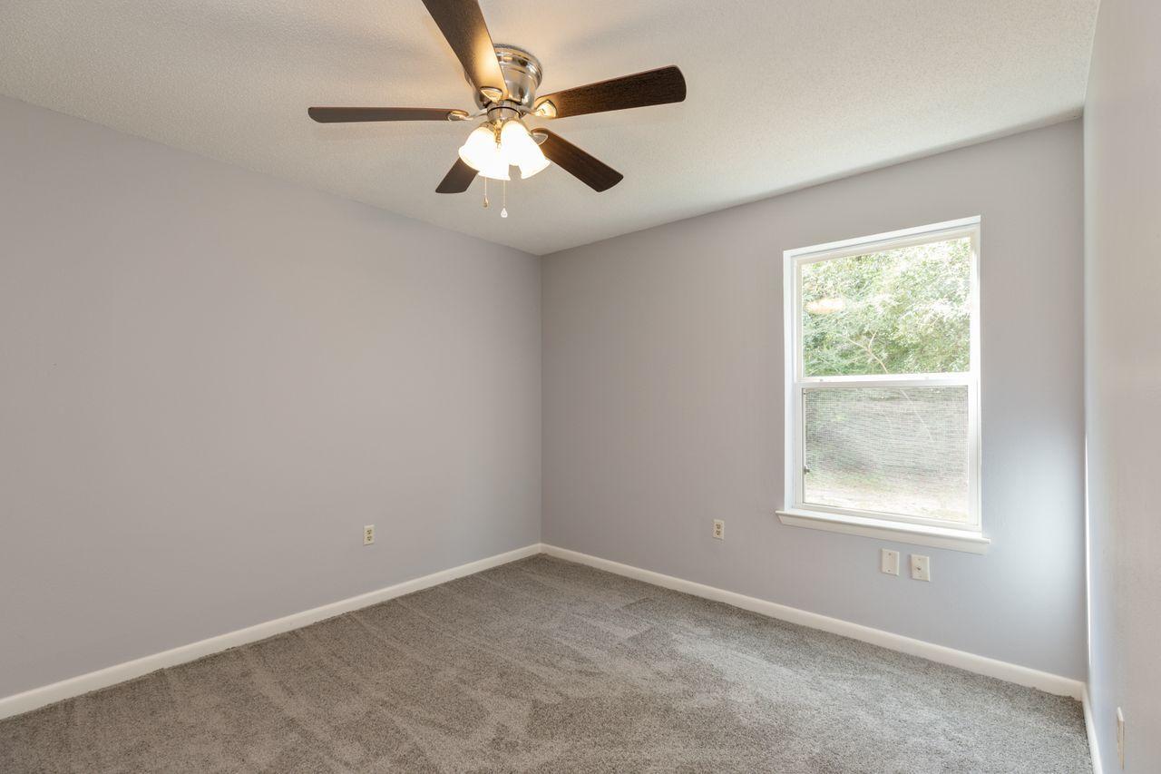 6130 Beasley Road Crestview, FL 32536 - Photo 11 of 28 an empty room with a window and a fan