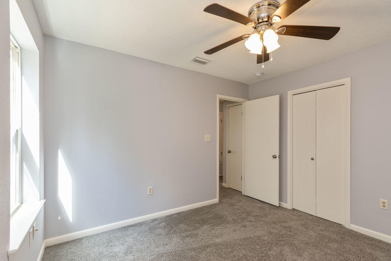 6130 Beasley Road Crestview, FL 32536 - Photo 13 of 28 an empty room with windows and fan