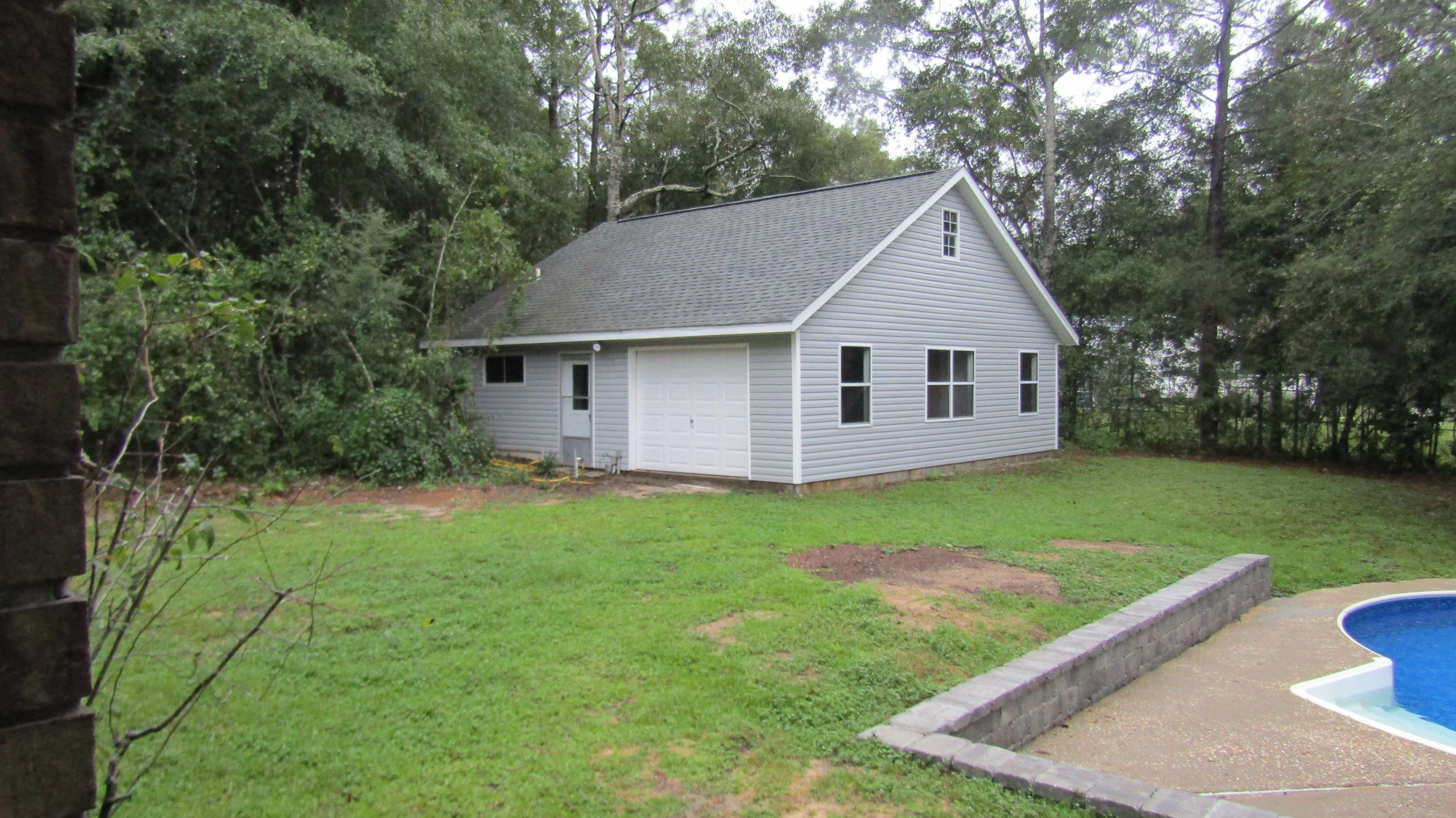 6130 Beasley Road Crestview, FL 32536 - Photo 14 of 28 a house with green field in front of it