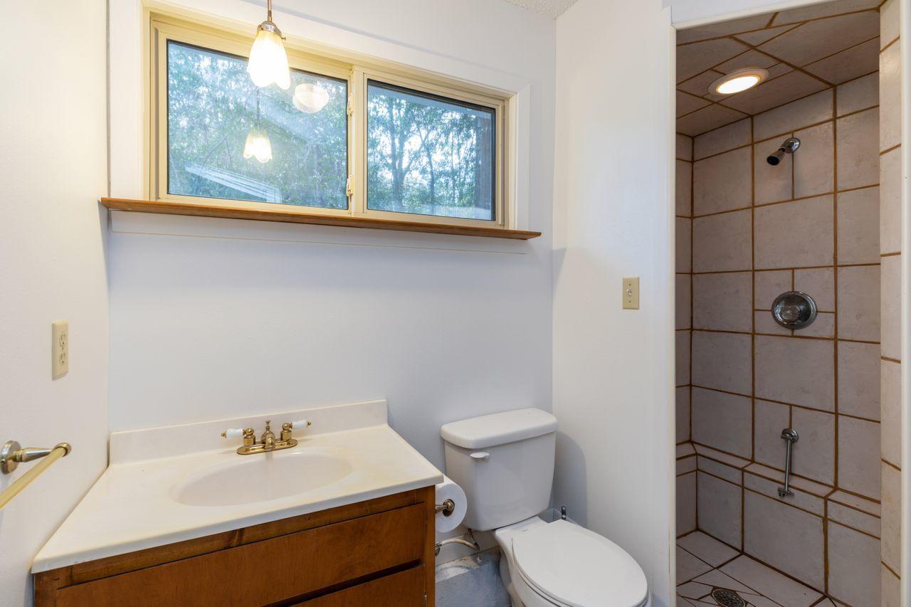 6130 Beasley Road Crestview, FL 32536 - Photo 16 of 28 a bathroom with a sink toilet and mirror