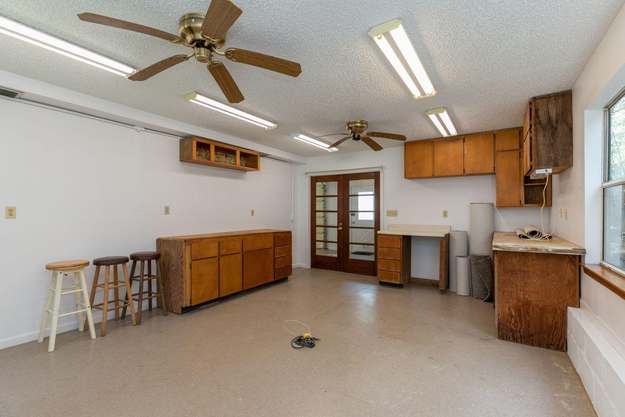 6130 Beasley Road Crestview, FL 32536 - Photo 17 of 28 a kitchen with stainless steel appliances kitchen island granite countertop a sink and cabinets