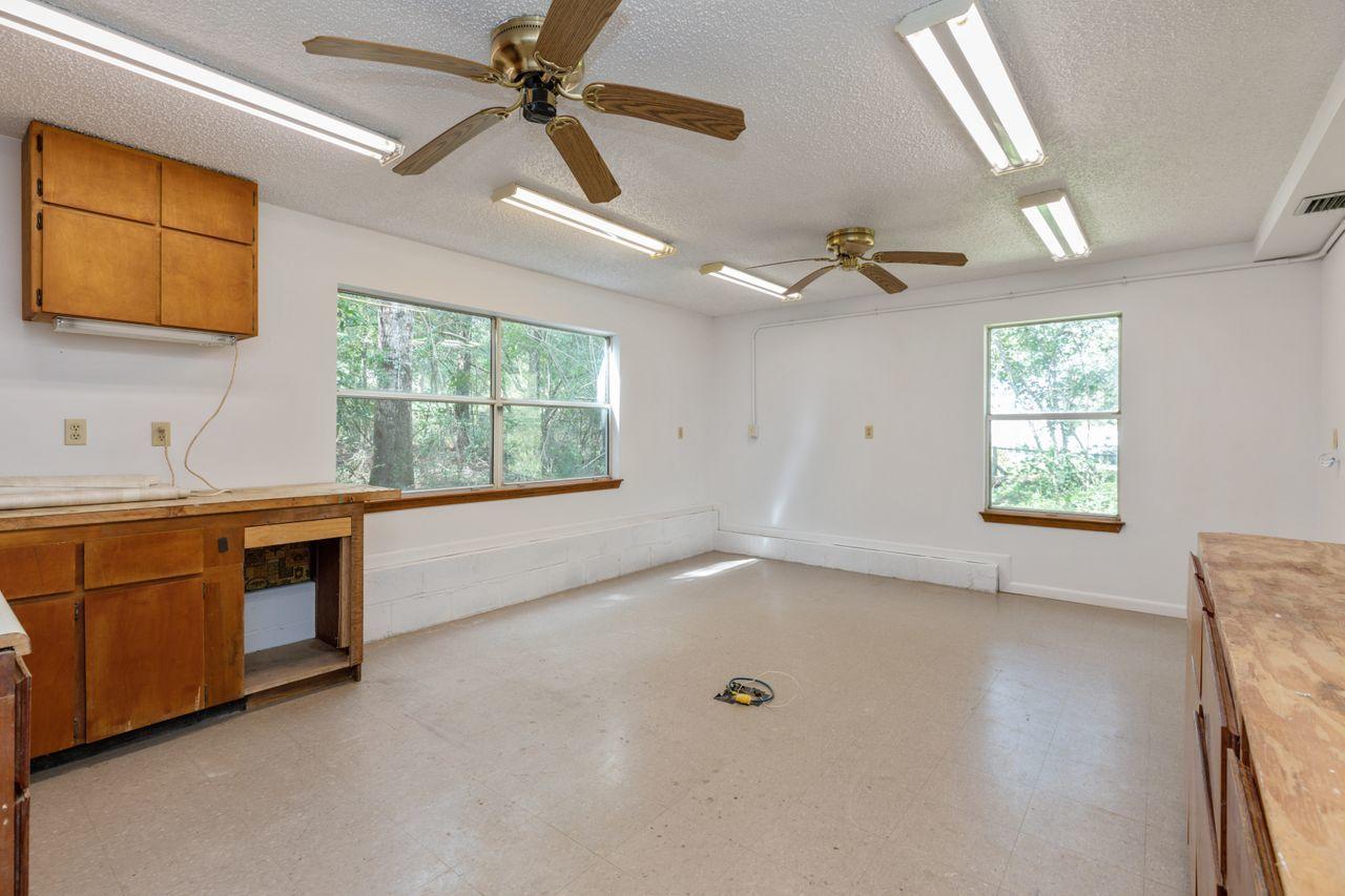 6130 Beasley Road Crestview, FL 32536 - Photo 18 of 28 a view of an empty room with window and cabinet