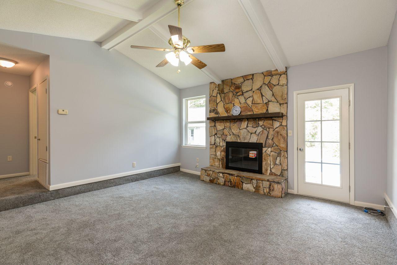 6130 Beasley Road Crestview, FL 32536 - Photo 3 of 28 an empty room with windows fireplace and fan