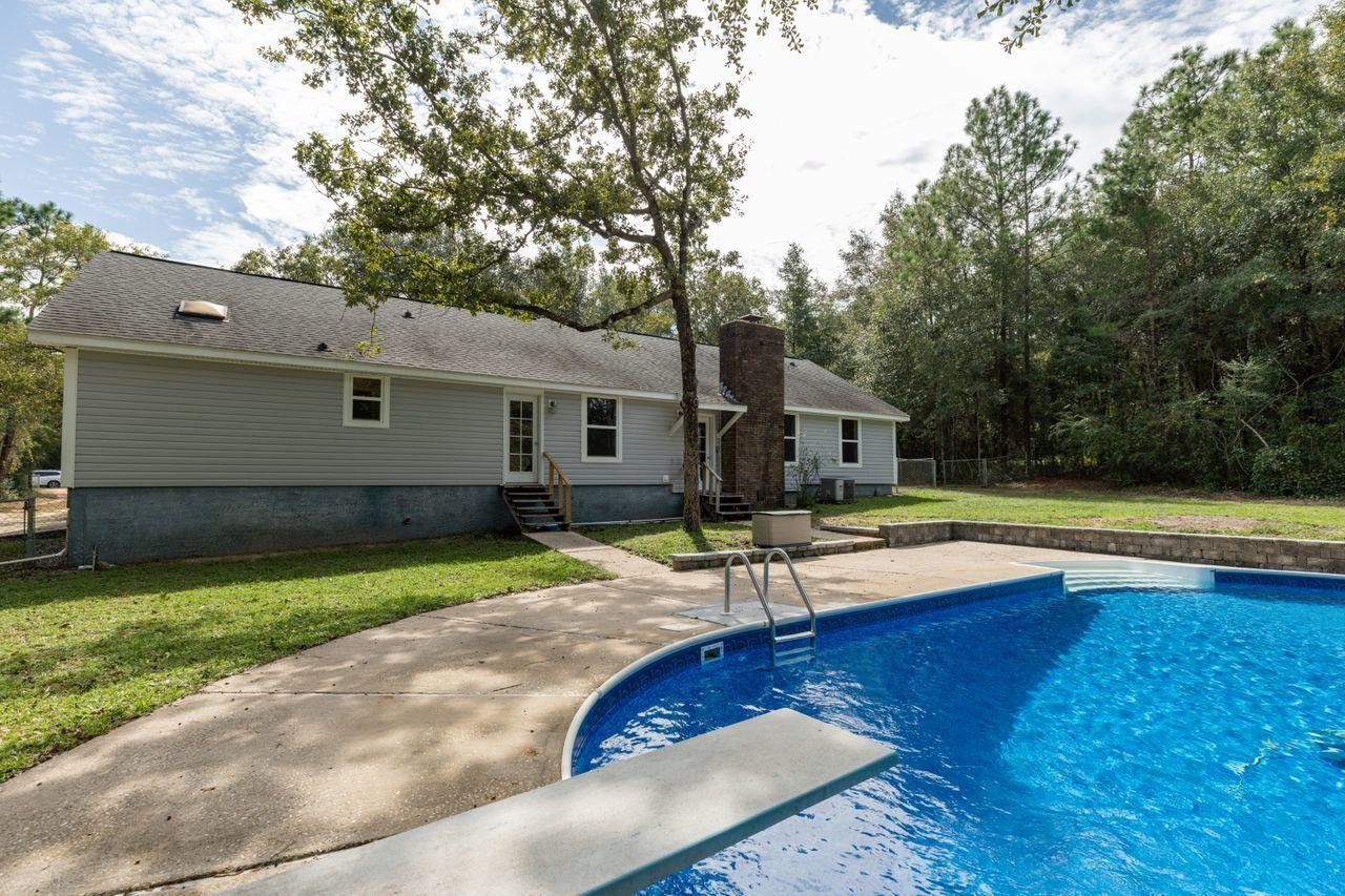 6130 Beasley Road Crestview, FL 32536 - Photo 23 of 28 a view of a house with pool and a yard