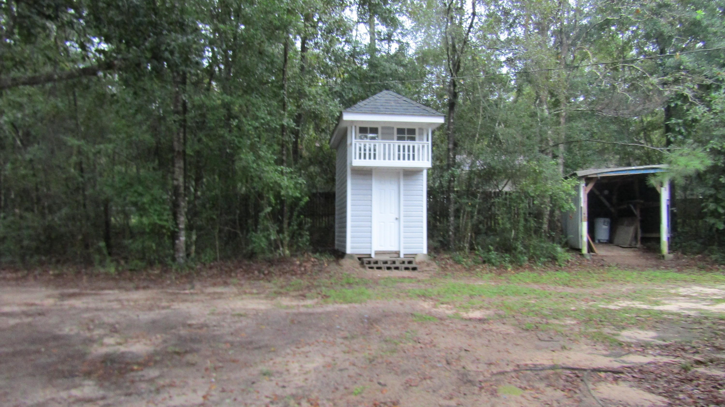 6130 Beasley Road Crestview, FL 32536 - Photo 25 of 28 a front view of a house with yard and trees