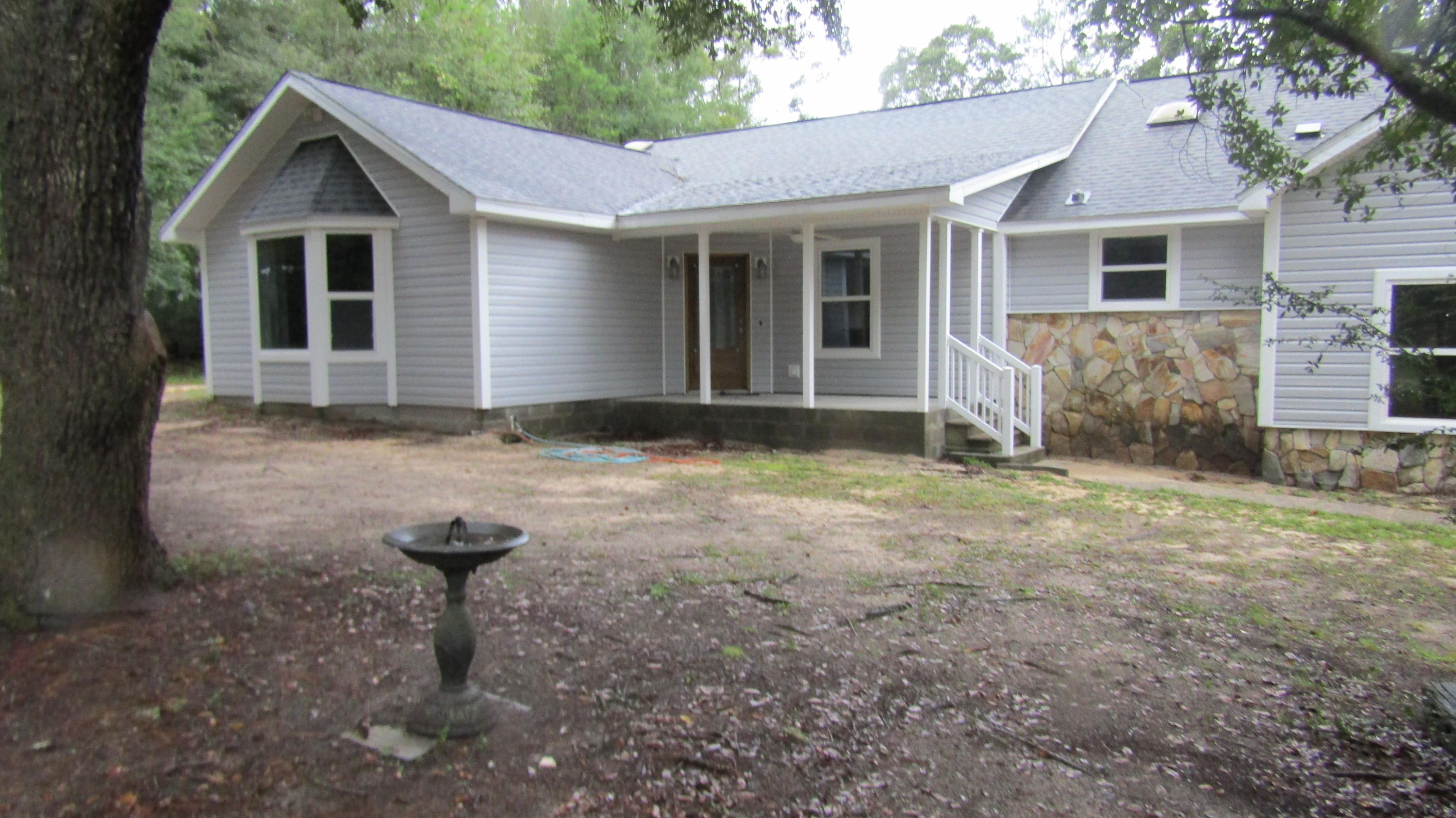 6130 Beasley Road Crestview, FL 32536 - Photo 26 of 28 a front view of a house with garden