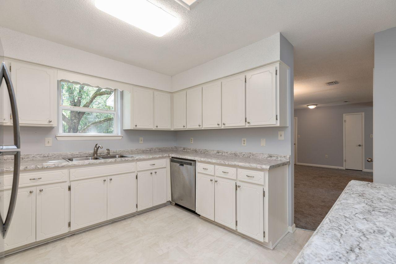 6130 Beasley Road Crestview, FL 32536 - Photo 5 of 28 a kitchen with a sink stove and cabinets