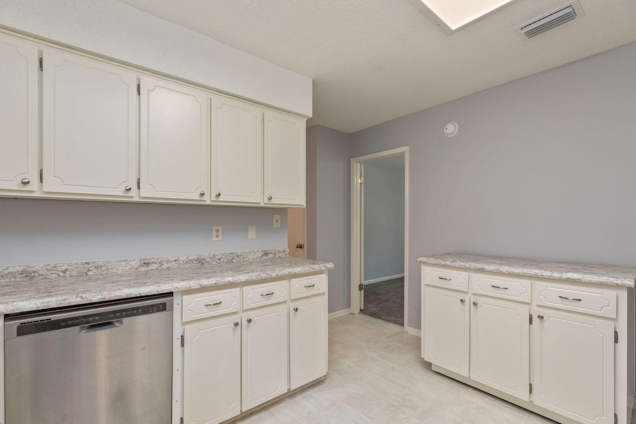 6130 Beasley Road Crestview, FL 32536 - Photo 6 of 28 a kitchen with white cabinets