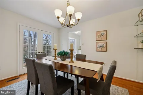 a view of a dining room with furniture wooden floor and a chandelier