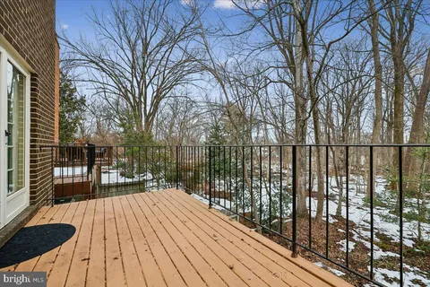 a view of balcony with wooden floor and fence