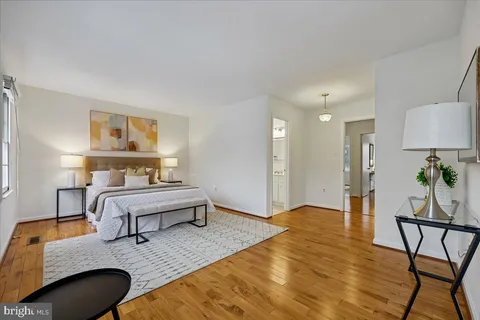a bedroom with furniture and a wooden floor