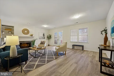 a living room with furniture a fireplace and a window