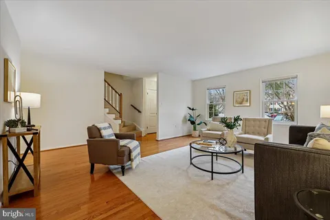 a living room with furniture a rug and a window