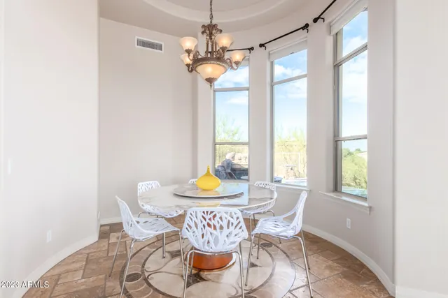 a view of a refrigerator in kitchen and an empty room