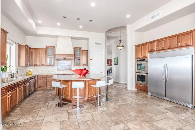 a kitchen with a sink stove and cabinets