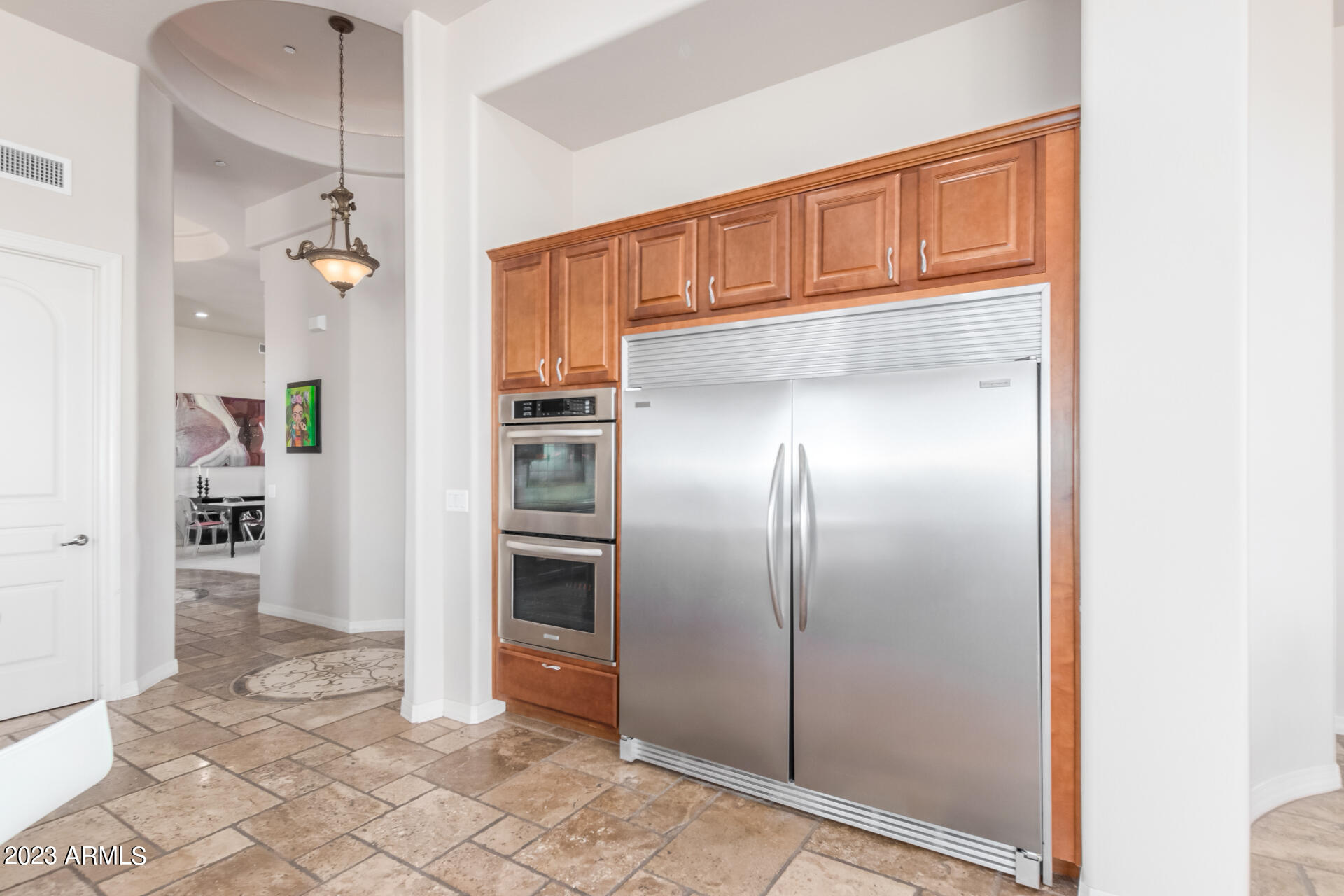 14234 North 27th Place Phoenix, AZ 85032 - Photo 15 of 66 a view of a refrigerator in kitchen and an empty room