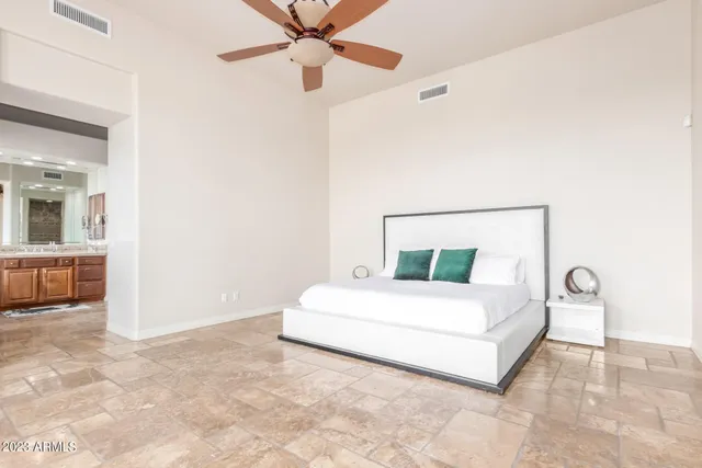 a bed room with a bed and a potted plant