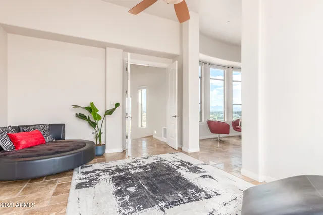 a bedroom with a bed and a large window