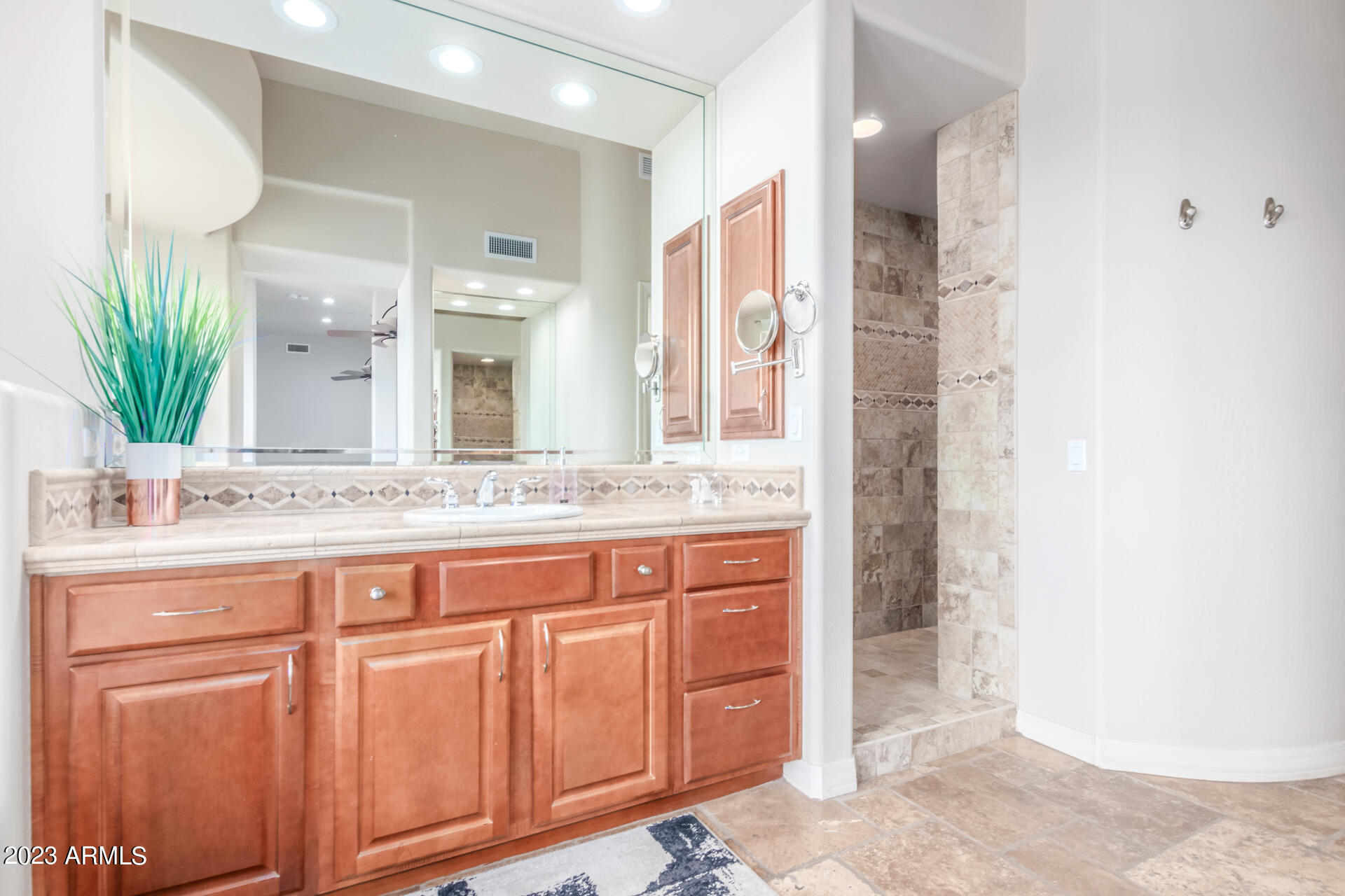 14234 North 27th Place Phoenix, AZ 85032 - Photo 24 of 66 a bathroom with a granite countertop sink a mirror and a shower