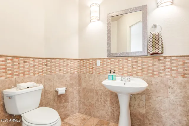 a living room with furniture a flat screen tv and a floor to ceiling window