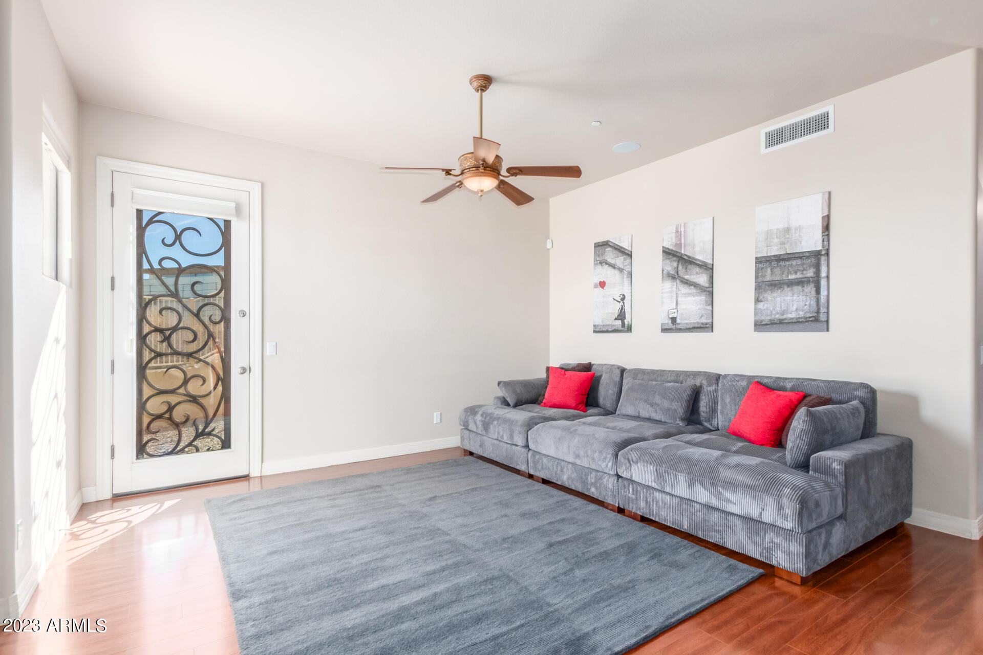 14234 North 27th Place Phoenix, AZ 85032 - Photo 39 of 66 a living room with couch and a wooden floor