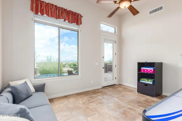 a living room with furniture and a floor to ceiling window