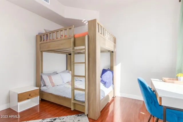 a view of a living room with furniture and floor to ceiling window