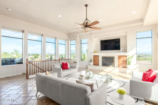 a living room with furniture a fireplace and a flat screen tv