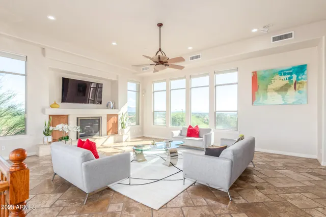 a living room with kitchen island furniture and a chandelier