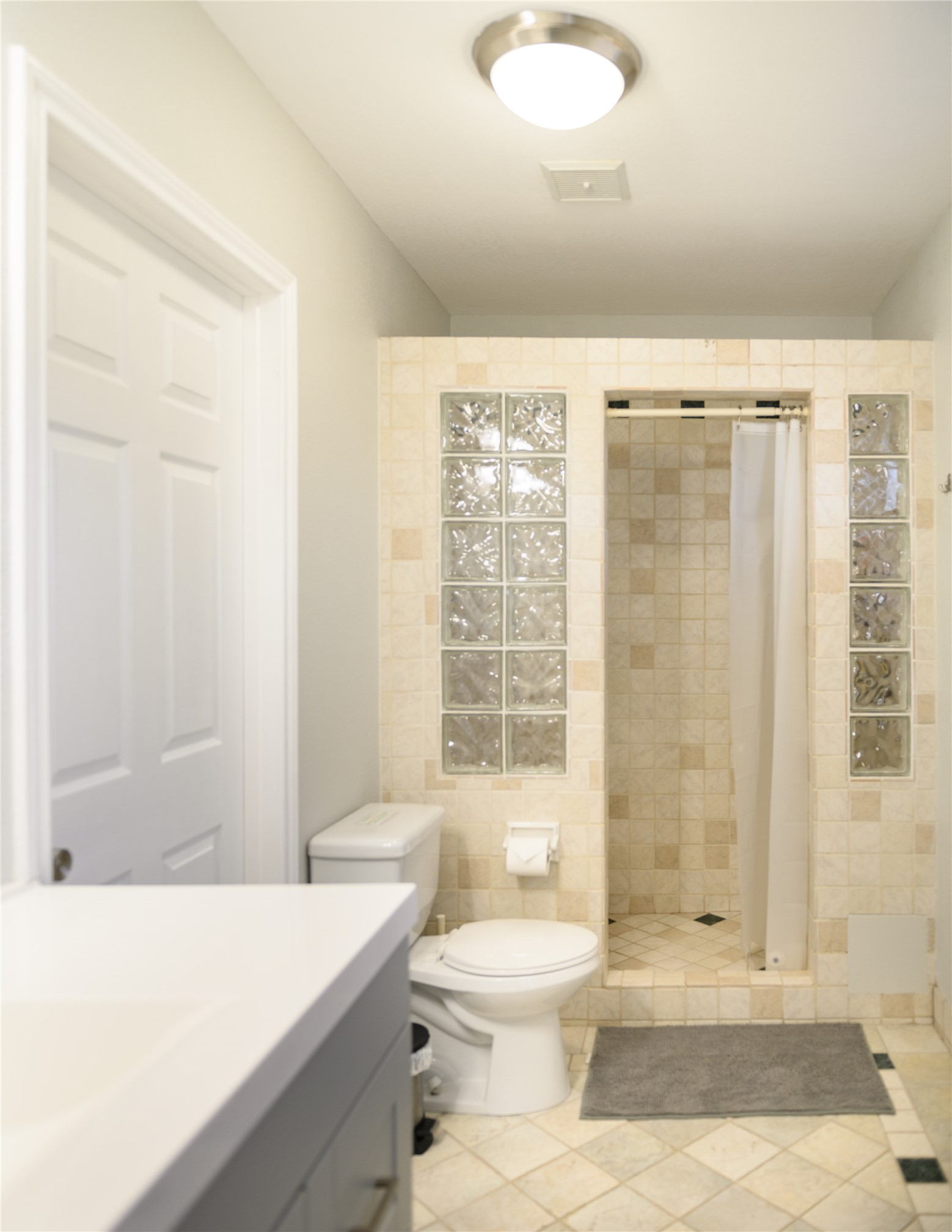 4902 Pecan Springs Road Austin, TX 78723 - Photo 38 of 40 a bathroom with a sink toilet and shower