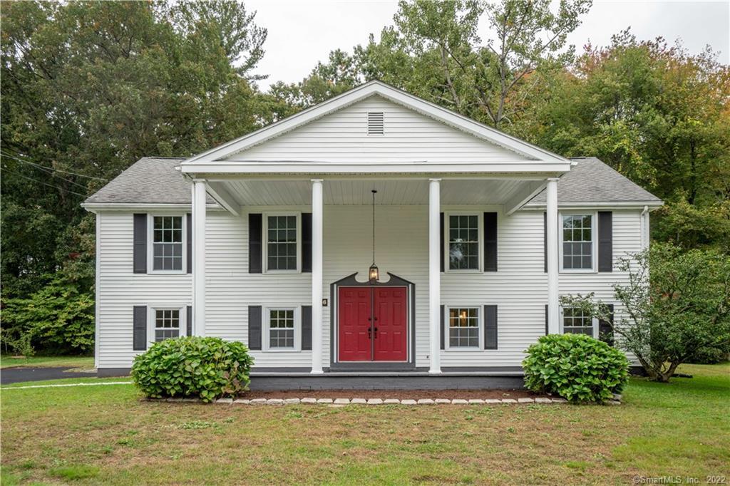 56 Post Road Enfield, CT 06082 - Photo 1 of 1 a front view of a house with a yard
