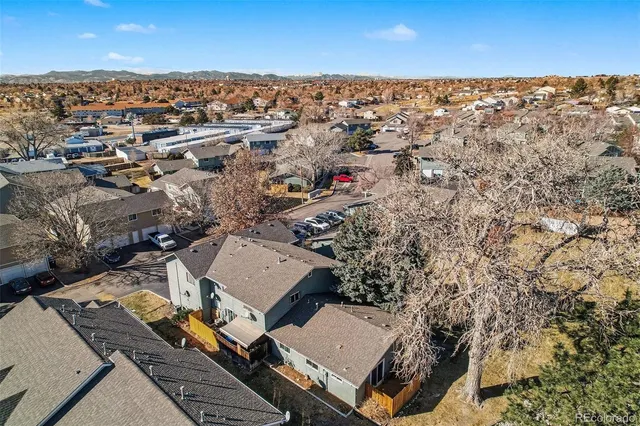 an aerial view of a house with a yard