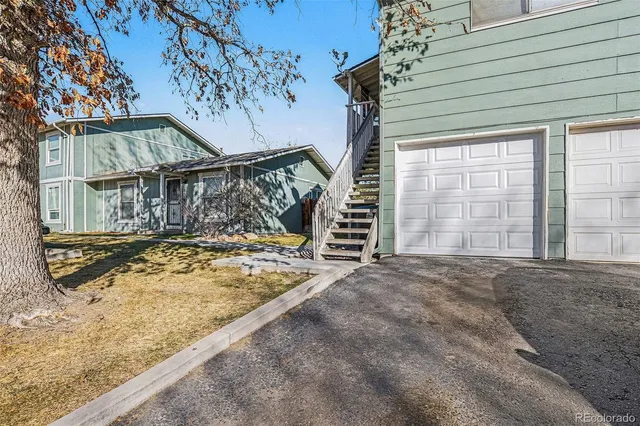a view of a house with a snow in the yard