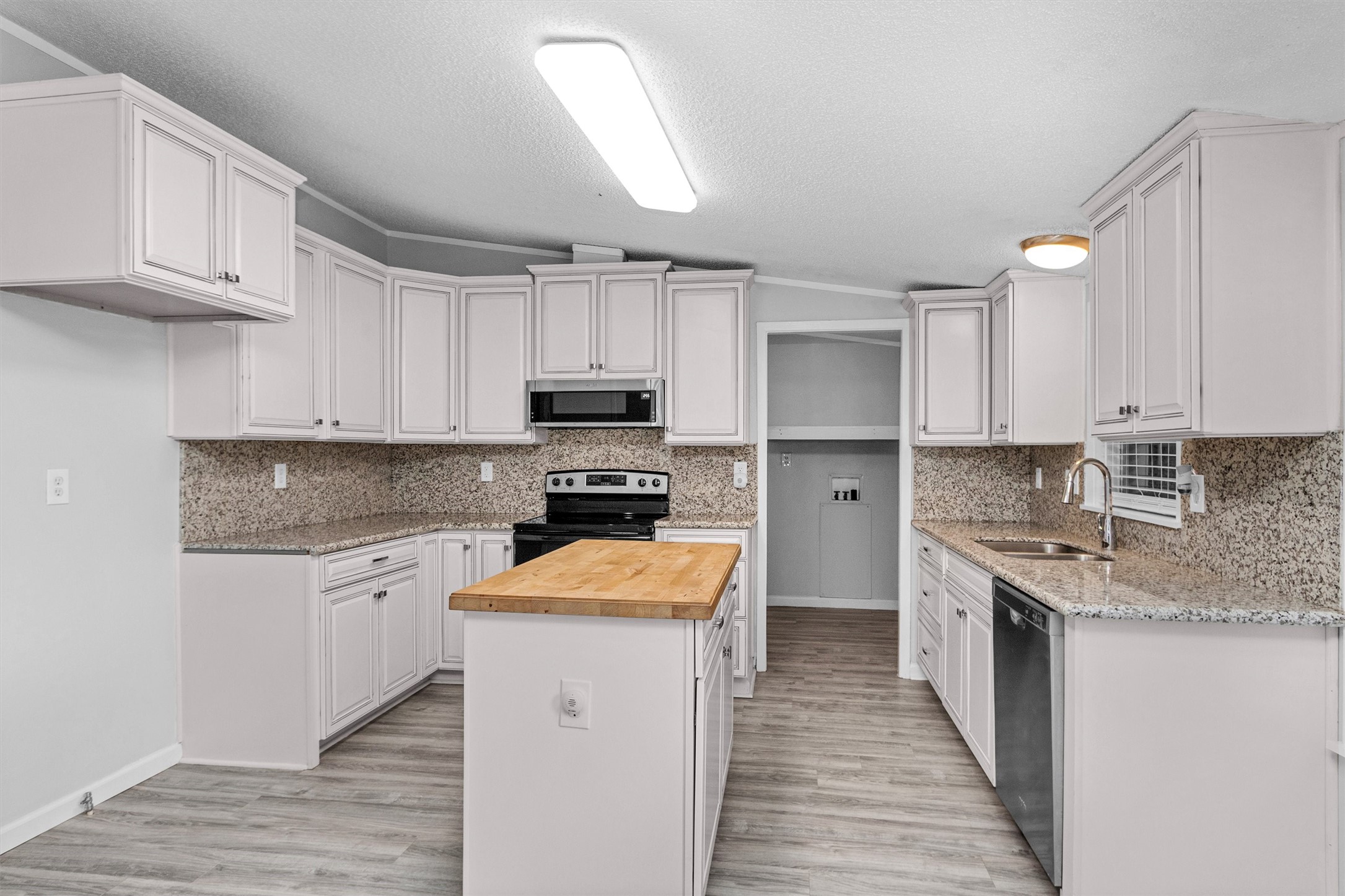 4621 Price Road Montgomery, TX 77316 - Photo 11 of 50 a kitchen with a sink stove top oven and refrigerator