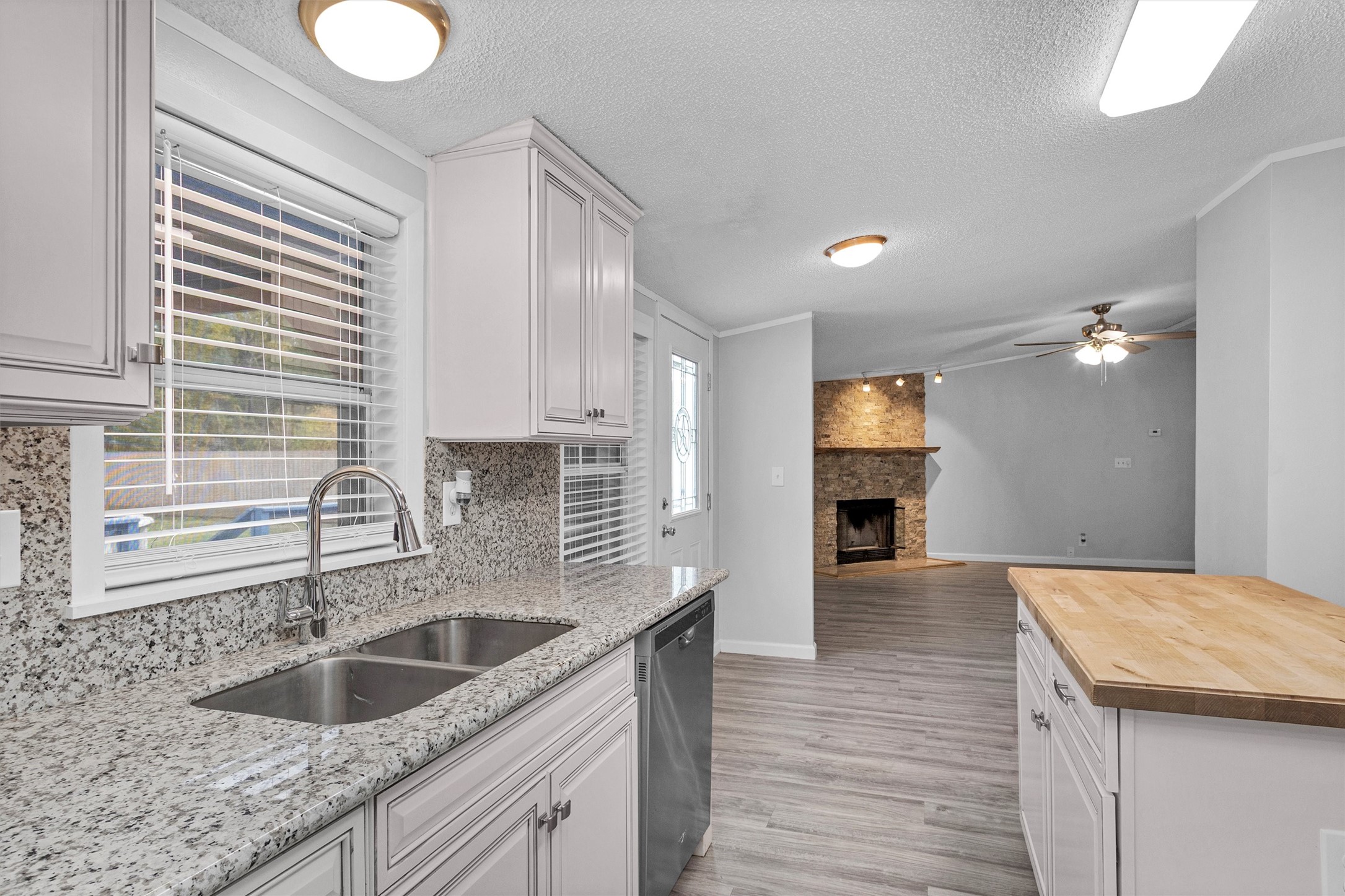 4621 Price Road Montgomery, TX 77316 - Photo 14 of 50 a kitchen with granite countertop a sink and a wooden floor