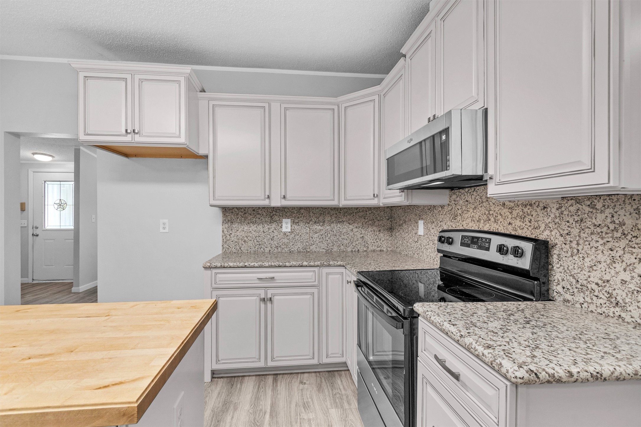 4621 Price Road Montgomery, TX 77316 - Photo 15 of 50 a kitchen with stainless steel appliances granite countertop a stove and a sink