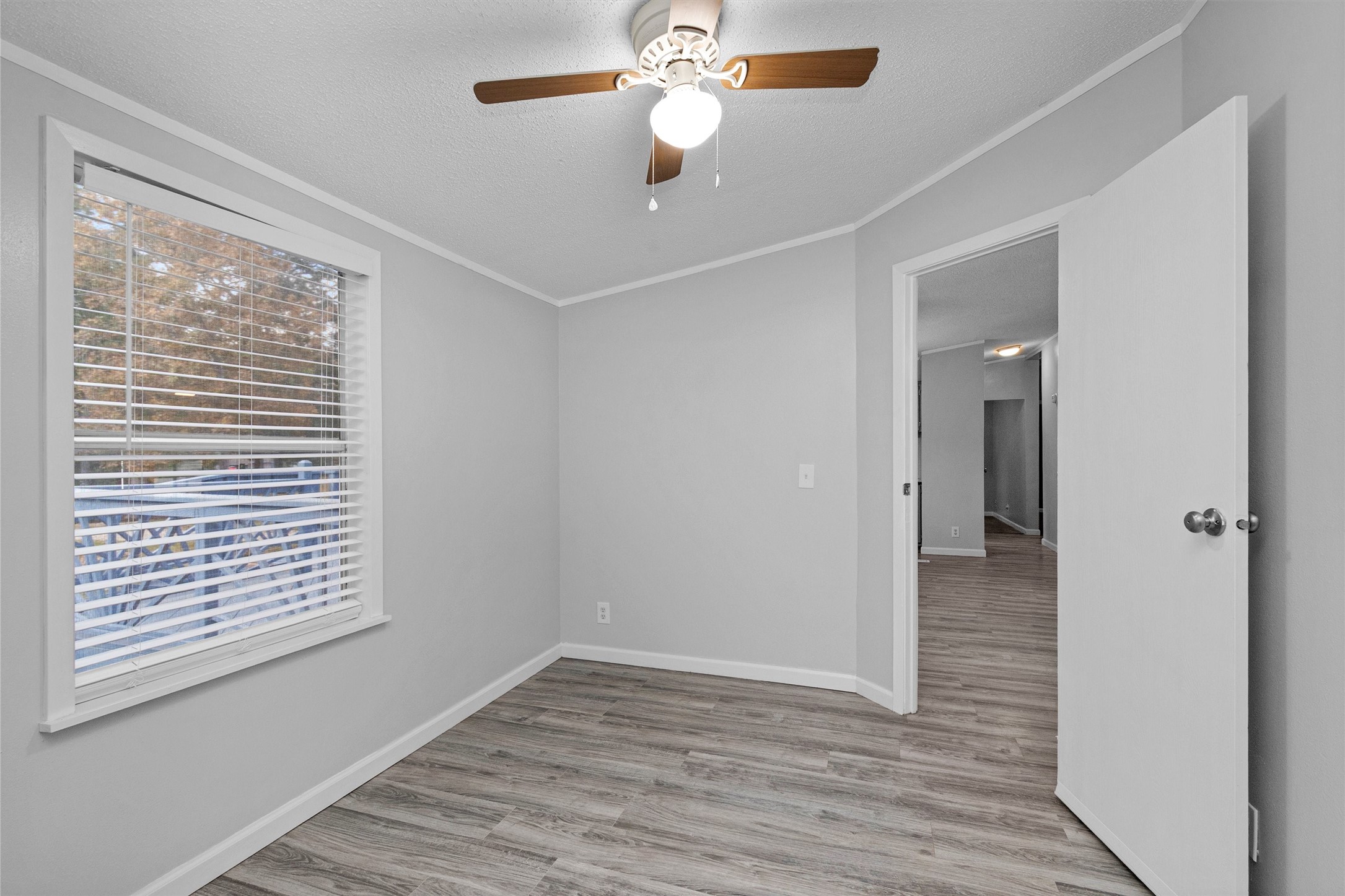 4621 Price Road Montgomery, TX 77316 - Photo 19 of 50 a view of an empty room with wooden floor and a window