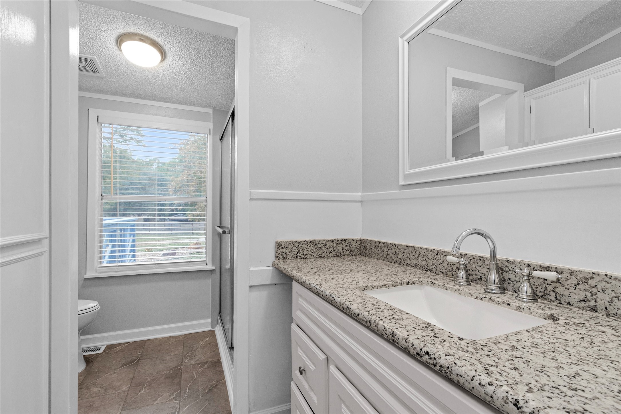 4621 Price Road Montgomery, TX 77316 - Photo 22 of 50 a bathroom with a granite countertop sink and a mirror