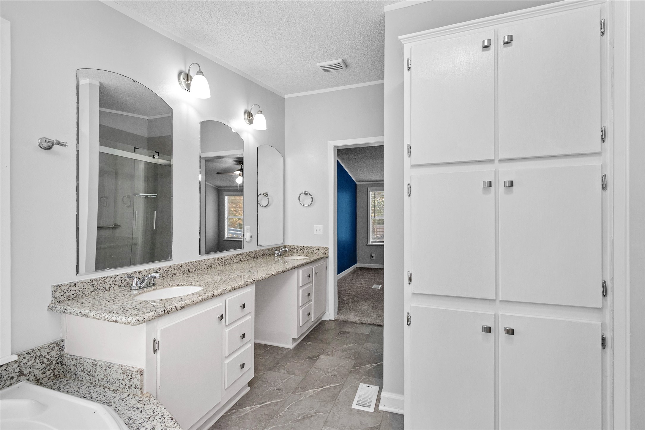 4621 Price Road Montgomery, TX 77316 - Photo 32 of 50 a spacious bathroom with a granite countertop sink and a mirror