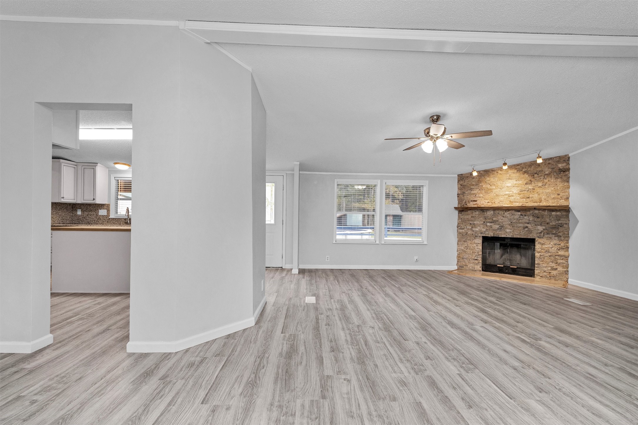 4621 Price Road Montgomery, TX 77316 - Photo 7 of 50 a view of an empty room with wooden floor fireplace and a window