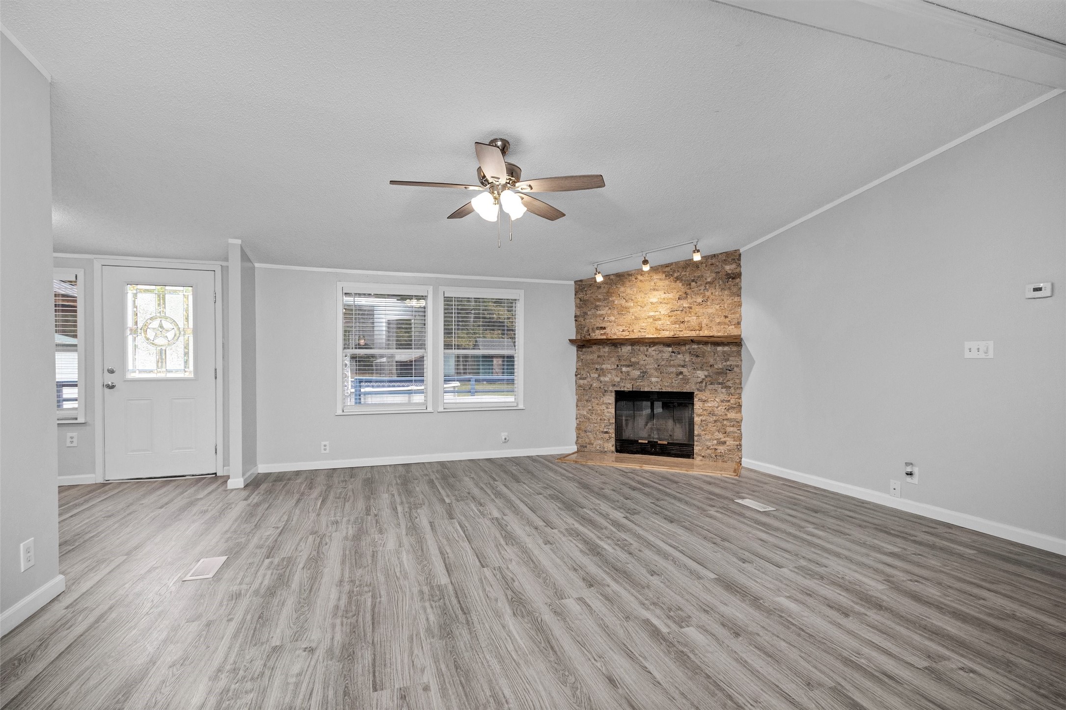 4621 Price Road Montgomery, TX 77316 - Photo 8 of 50 wooden floor fireplace and windows in an empty room