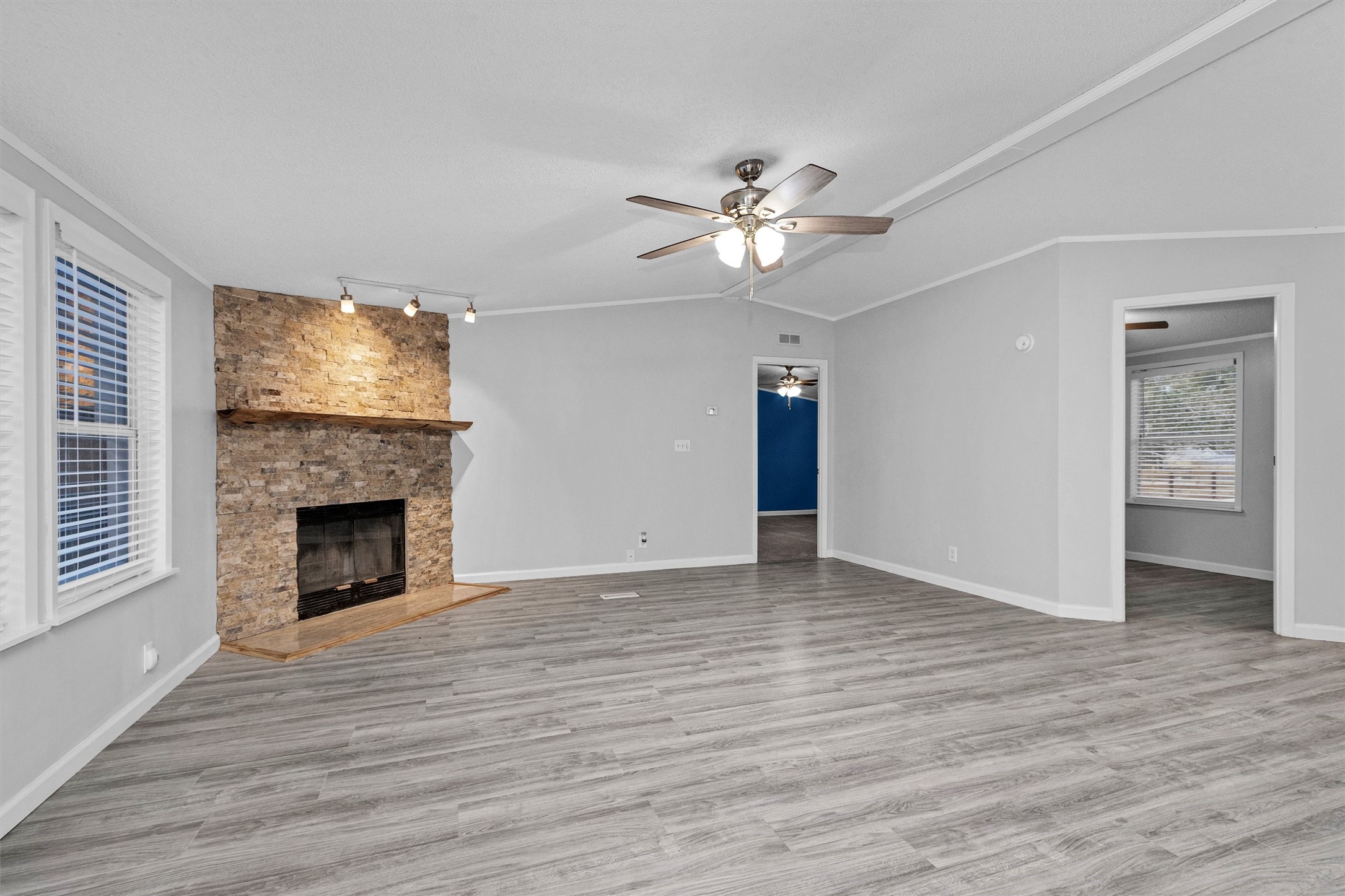 4621 Price Road Montgomery, TX 77316 - Photo 9 of 50 a view of an empty room with wooden floor fireplace and a window
