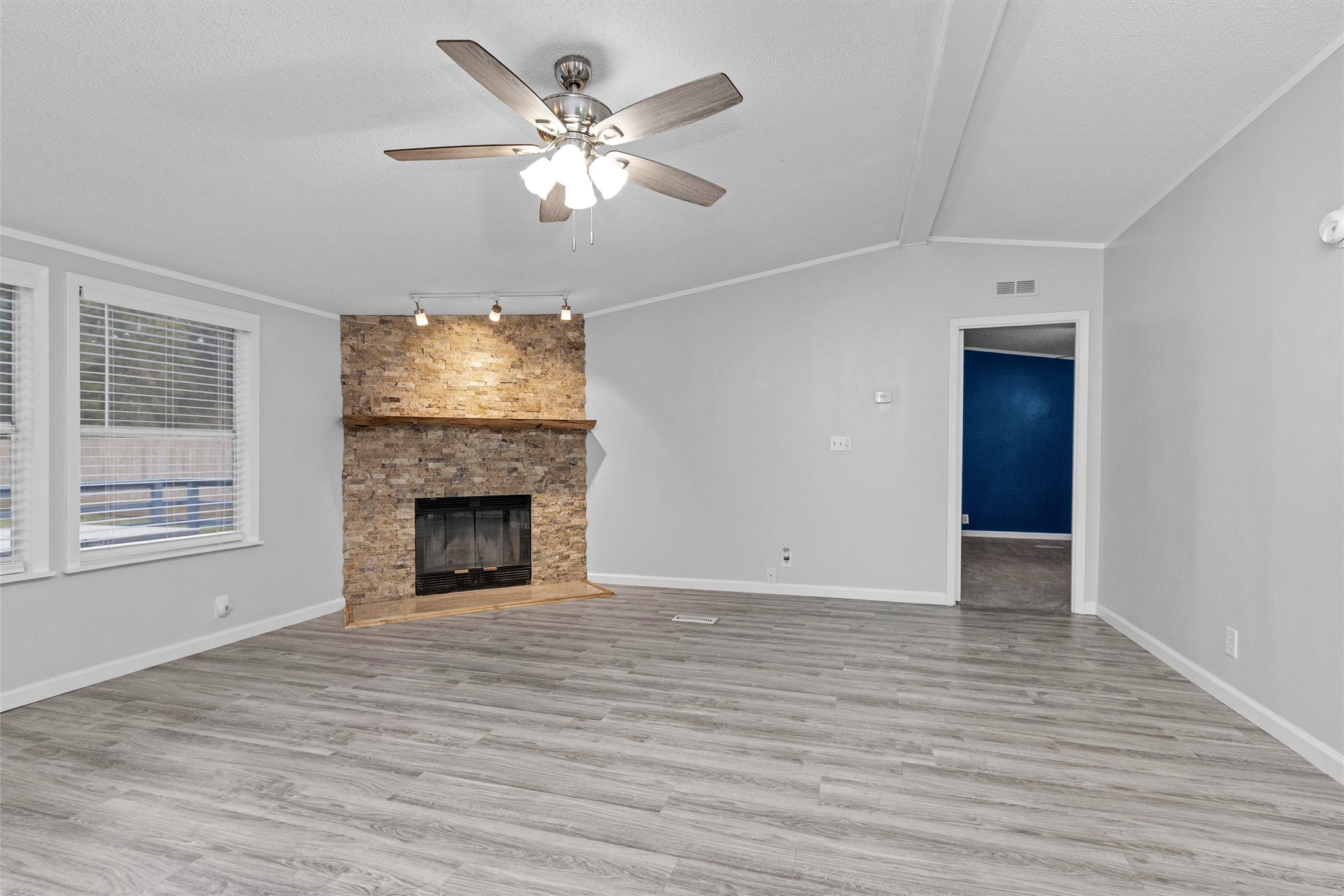 4621 Price Road Montgomery, TX 77316 - Photo 10 of 50 a view of an empty room with wooden floor and a fireplace